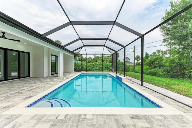 view of swimming pool featuring a lanai and a patio