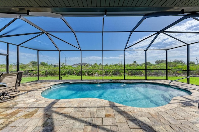 view of pool with a patio, pool water feature, and a lanai