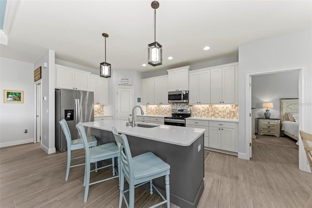 kitchen featuring white cabinets, sink, and appliances with stainless steel finishes