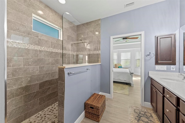 bathroom with vanity and a tile shower