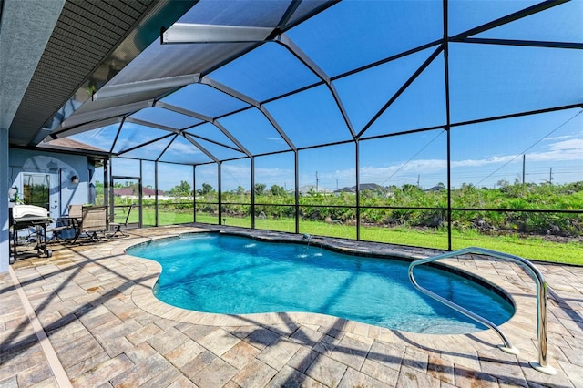 view of swimming pool featuring glass enclosure, grilling area, and a patio area