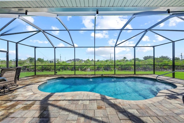 view of pool featuring glass enclosure, pool water feature, and a patio