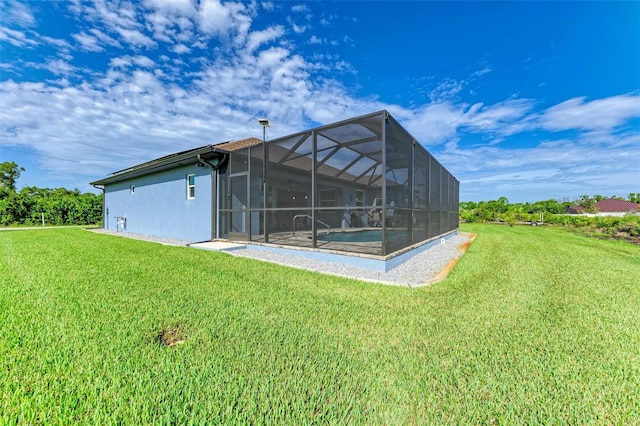 back of property with a yard and glass enclosure