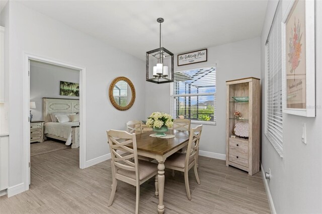 dining room featuring a chandelier and light wood-type flooring