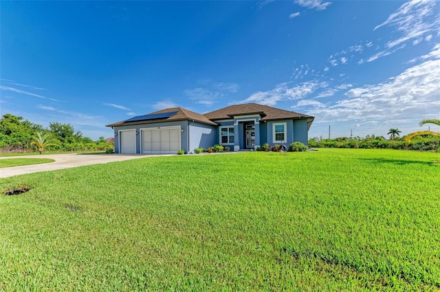 single story home with a front yard, solar panels, and a garage