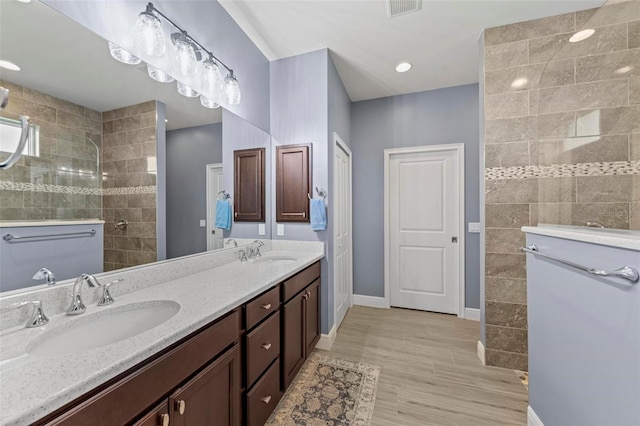 bathroom featuring vanity and tiled shower