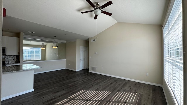 unfurnished living room with ceiling fan, dark wood-type flooring, and lofted ceiling