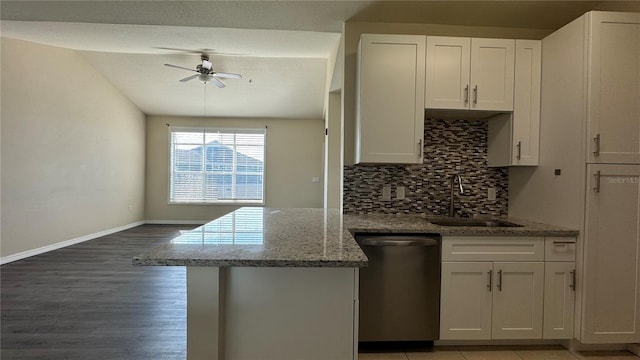 kitchen with decorative backsplash, ceiling fan, sink, white cabinetry, and stainless steel dishwasher