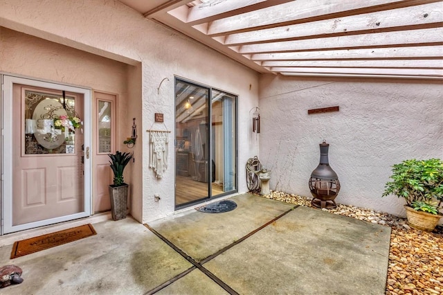 entrance to property with a patio area