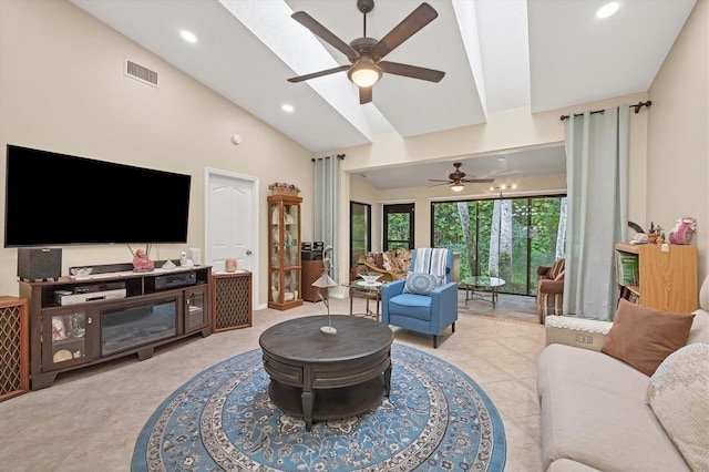 tiled living room featuring high vaulted ceiling, a skylight, and ceiling fan