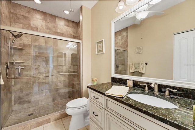 bathroom with vanity, walk in shower, toilet, tile patterned floors, and ceiling fan