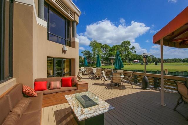 wooden deck featuring a lawn and an outdoor living space