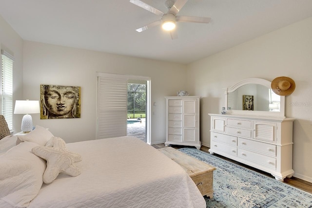 bedroom featuring ceiling fan, access to exterior, and hardwood / wood-style flooring