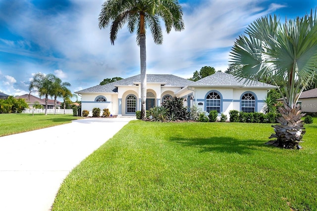 mediterranean / spanish house featuring a front yard