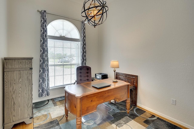 office area featuring a chandelier and baseboards