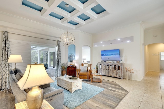 living room featuring a high ceiling, beam ceiling, crown molding, coffered ceiling, and arched walkways