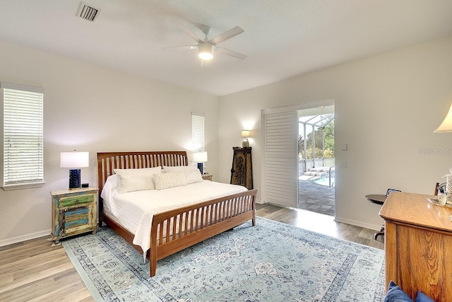 bedroom with baseboards, visible vents, a ceiling fan, and light wood finished floors