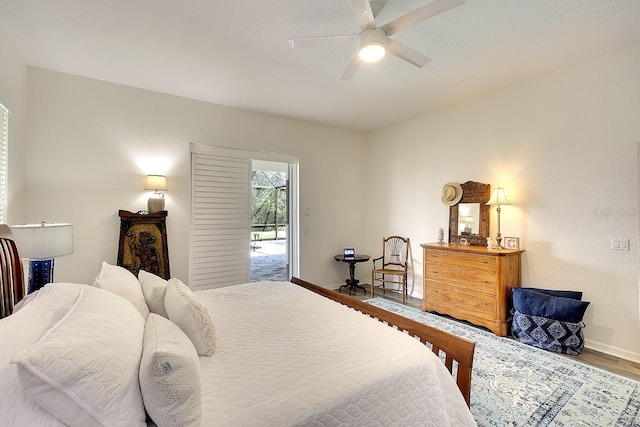 bedroom with baseboards, wood finished floors, and a ceiling fan