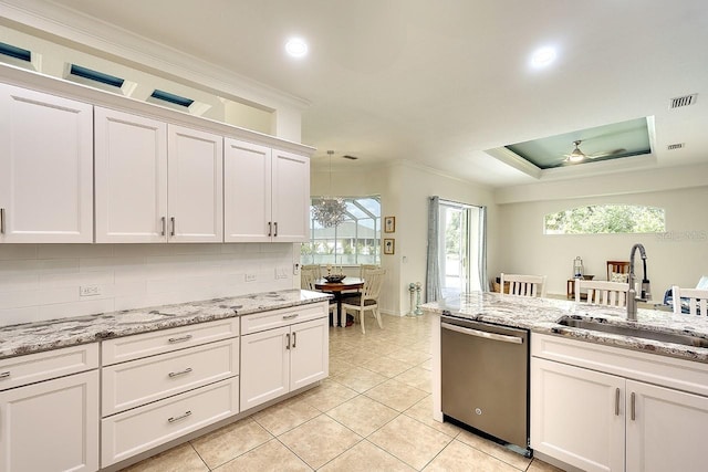 kitchen featuring tasteful backsplash, stainless steel dishwasher, white cabinets, a sink, and visible vents