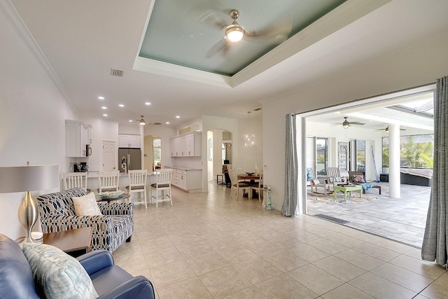 living area with arched walkways, ceiling fan, light tile patterned flooring, and crown molding
