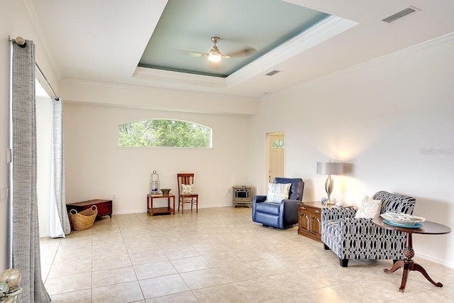 living area with visible vents, a ceiling fan, light tile patterned flooring, and crown molding