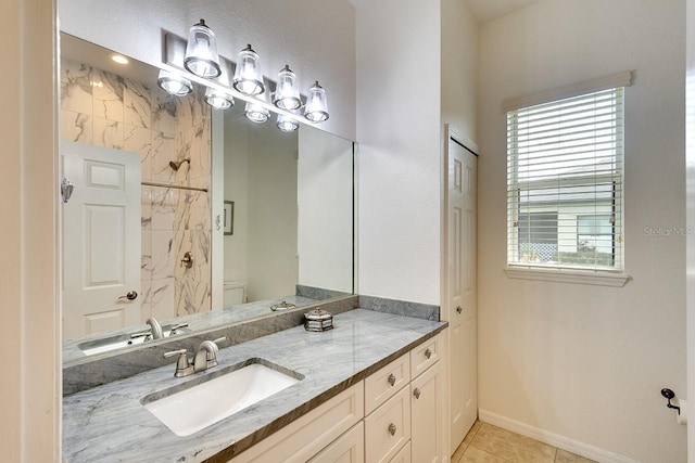 bathroom featuring a shower, baseboards, toilet, tile patterned floors, and vanity