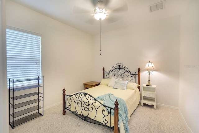 bedroom featuring baseboards, visible vents, a ceiling fan, and carpet