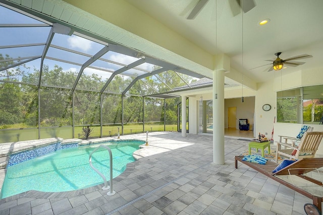 outdoor pool with a lanai, a ceiling fan, and a patio
