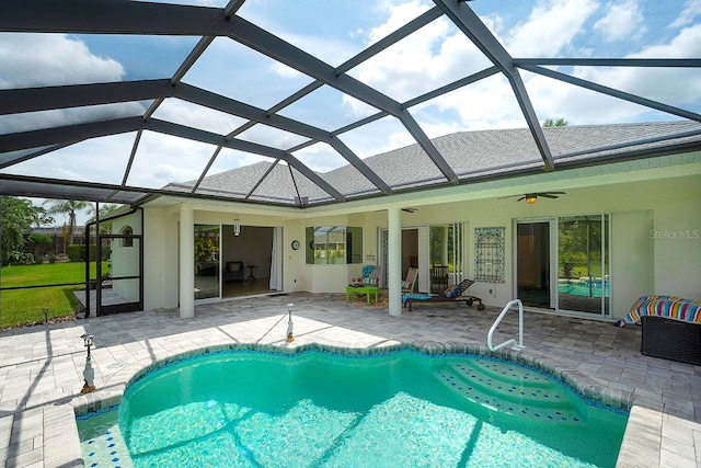 outdoor pool featuring a patio, ceiling fan, and glass enclosure