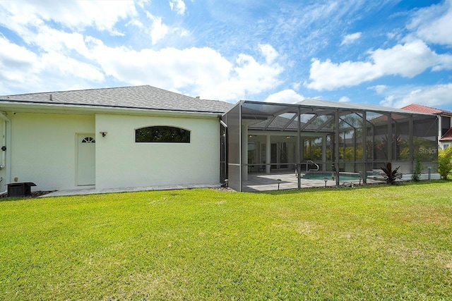 rear view of property with stucco siding, an outdoor pool, a lawn, and a patio area