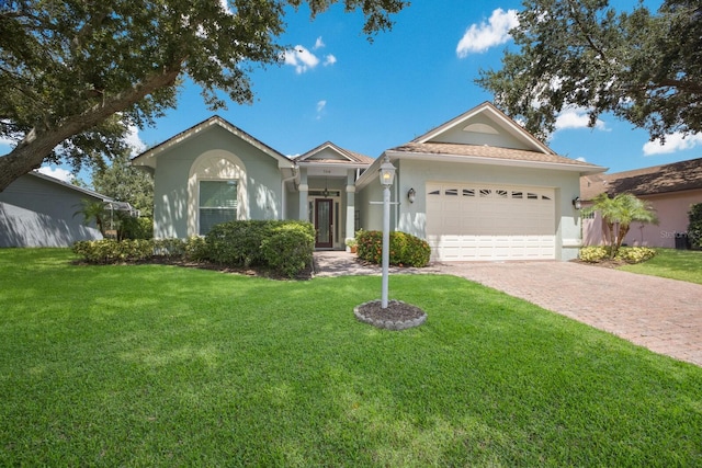 ranch-style home featuring a garage and a front lawn