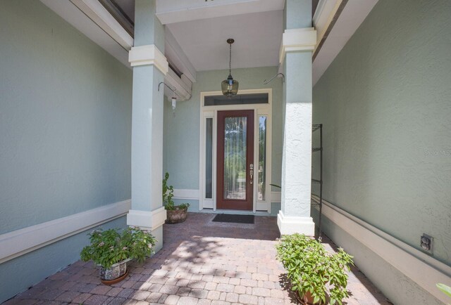 view of exterior entry featuring a porch