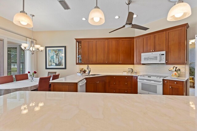 kitchen featuring white appliances, backsplash, sink, and pendant lighting