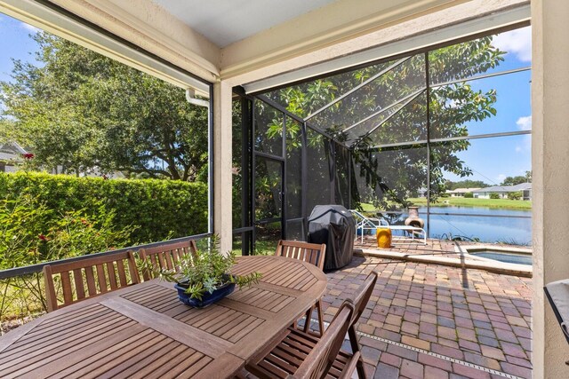 unfurnished sunroom featuring a water view