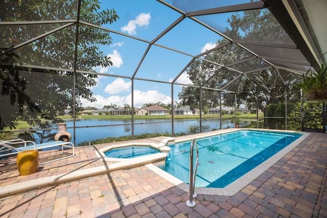 view of pool with a patio, an in ground hot tub, a water view, and a lanai