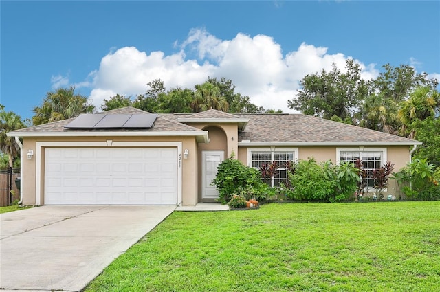 single story home featuring stucco siding, concrete driveway, a front yard, roof mounted solar panels, and a garage