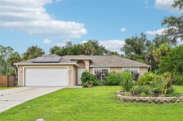 ranch-style home featuring a garage, driveway, roof mounted solar panels, a front lawn, and stucco siding