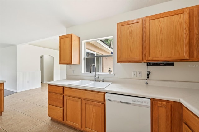 kitchen featuring dishwasher, sink, and light tile patterned flooring