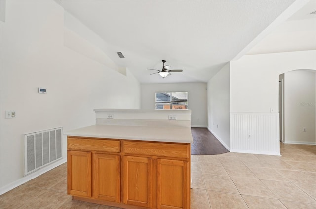 kitchen featuring ceiling fan, lofted ceiling, and light tile patterned floors