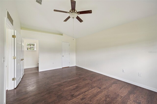 interior space with vaulted ceiling, dark wood-type flooring, ceiling fan, and a closet