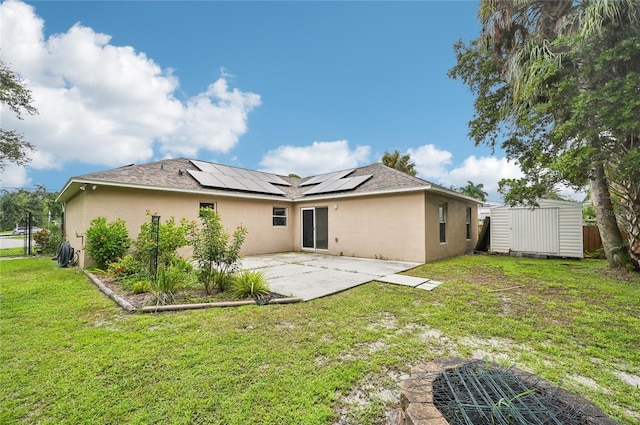 rear view of property featuring stucco siding, a patio area, an outdoor structure, and a storage unit