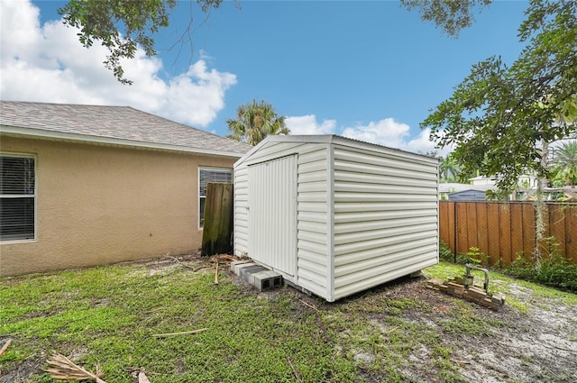 view of shed with fence