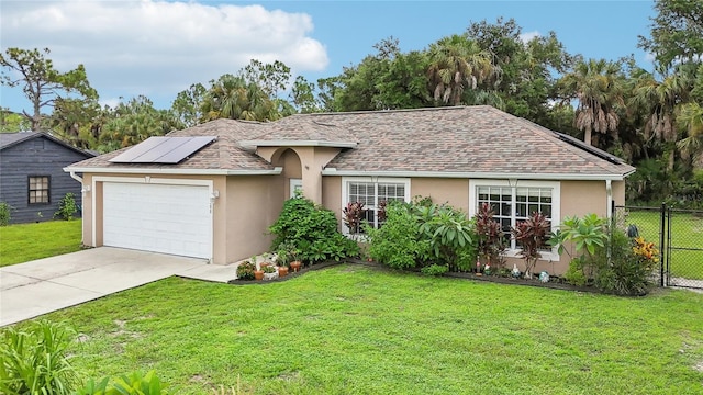 ranch-style home with a garage, a front lawn, and solar panels