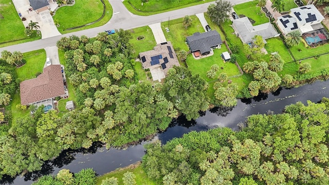 drone / aerial view with a water view and a residential view