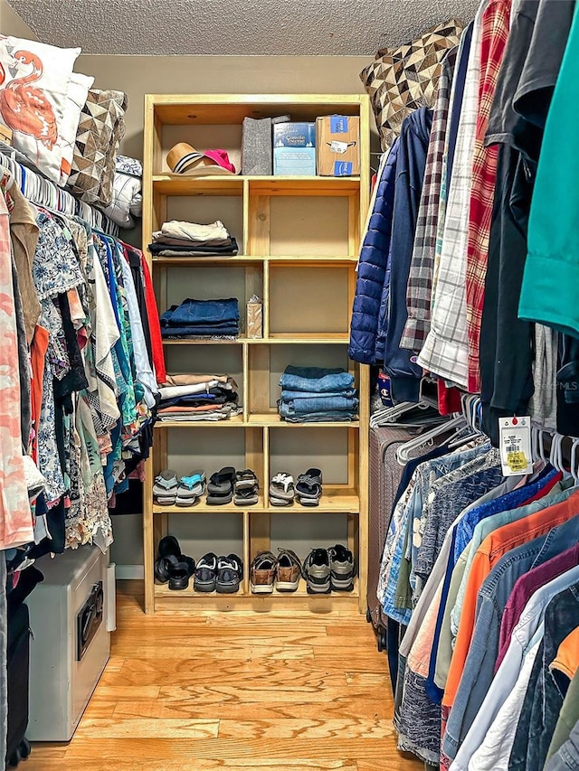 walk in closet with light wood-type flooring