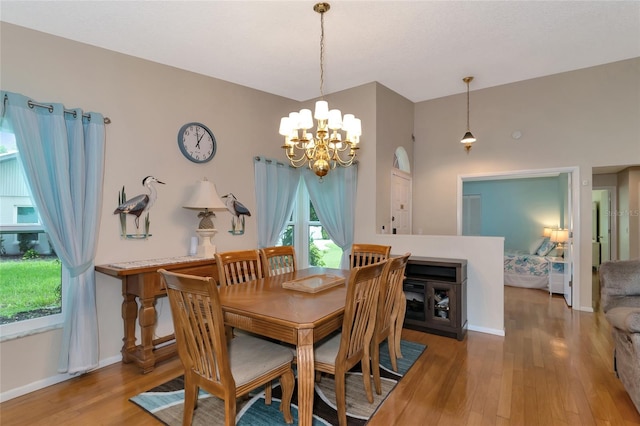 dining space featuring hardwood / wood-style floors and a chandelier