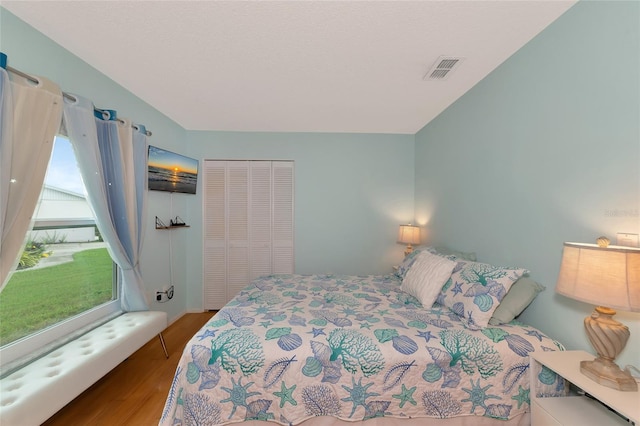 bedroom with hardwood / wood-style flooring and a closet