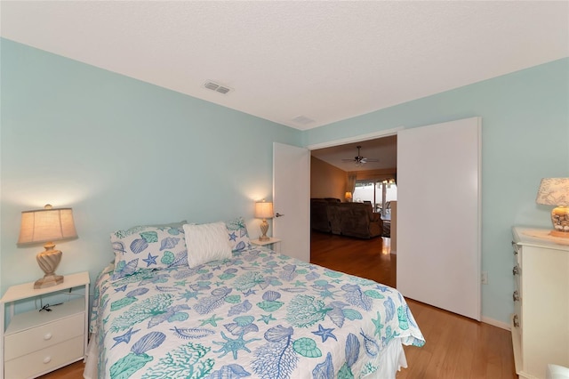 bedroom featuring hardwood / wood-style floors and a textured ceiling