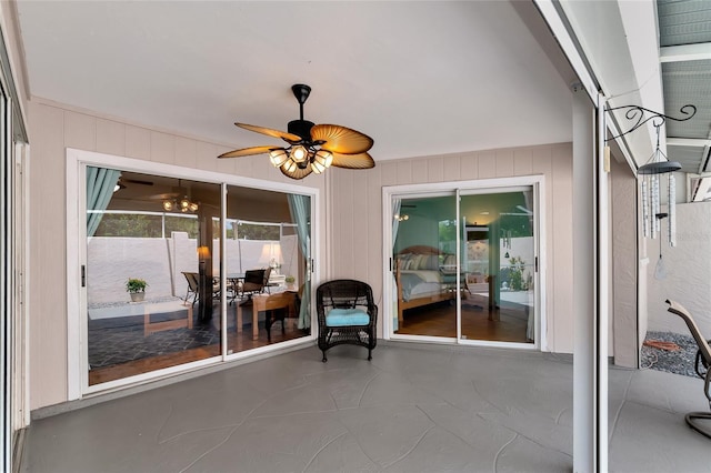 sunroom / solarium featuring ceiling fan