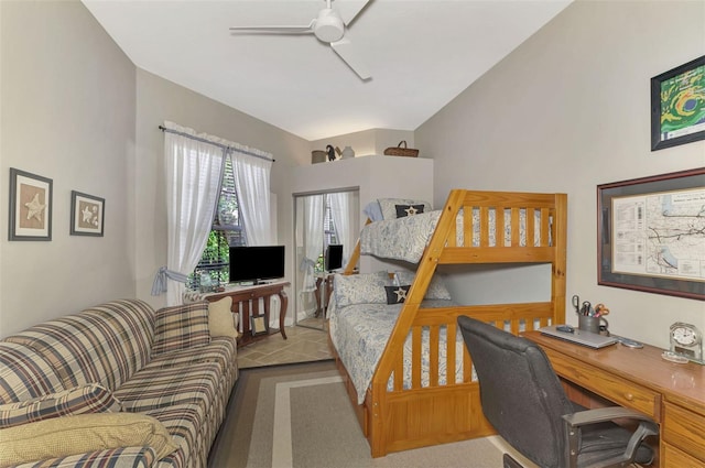 carpeted bedroom featuring ceiling fan and vaulted ceiling